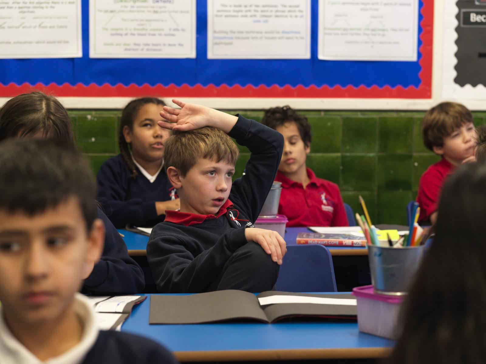 Boy raising his hand in school